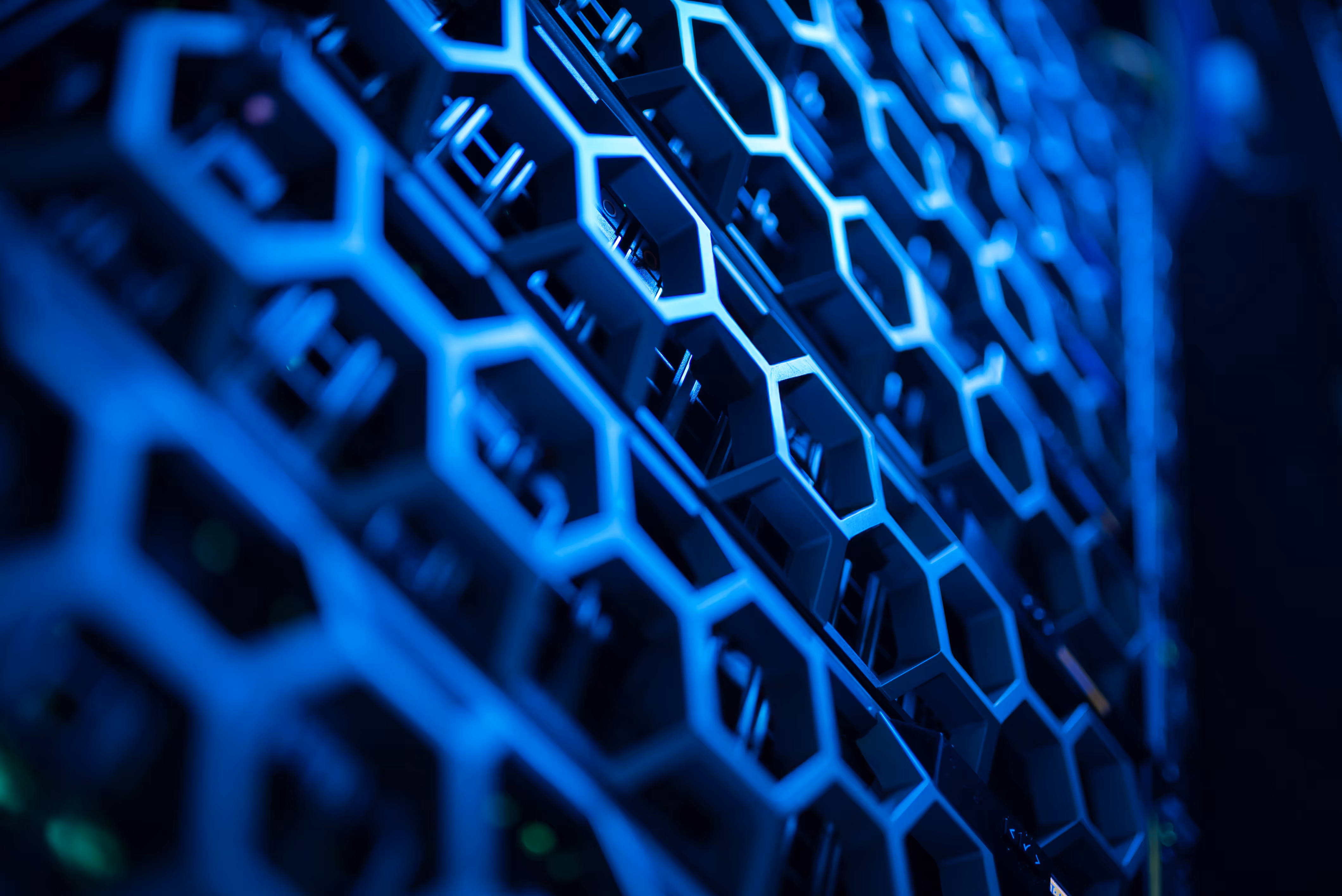 Close-up of blue hexagonal patterned metal server rack in a data center.
